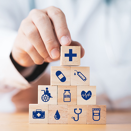 a stack of wooden blocks showing medical icons